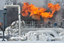Fire comes out of the top of two structures at the compressor station at Consumers Energy in Armada Township, Mich.