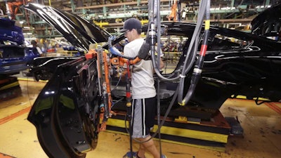 A United Auto Workers assemblyman works on the Ford Mustang at the Flat Rock Assembly Plant in Flat Rock, Mich.