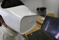 In this March 7, 2016 photo, Fove staff demonstrates virtual reality at an office in Tokyo.