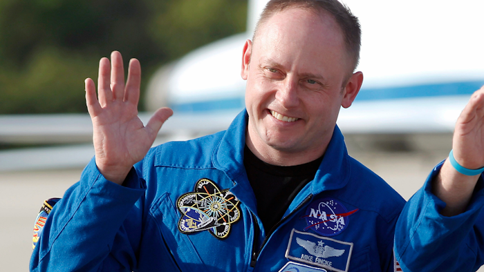 In this Tuesday, March 29, 2011, file photo, space shuttle Endeavour crew member Mike Fincke waves to onlookers after arriving for a practice countdown at Kennedy Space Center in Cape Canaveral, Fla.