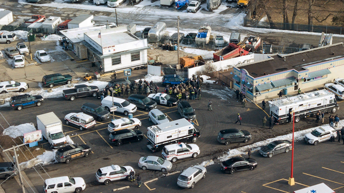 First responders and emergency vehicles are gathered near the scene of a shooting at an industrial park in Aurora, Ill., on Friday, Feb. 15, 2019.