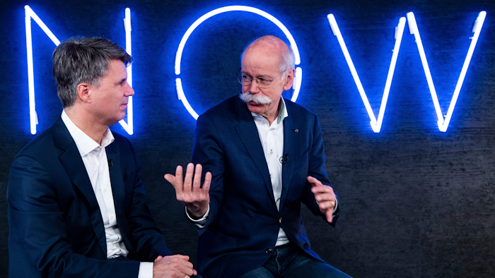 In this Friday, Feb. 22, 2019, photo, Harald Krueger, left, CEO of BMW, and Dieter Zetsche, right, CEO of Mercedes-Benz, talk during a press conference in Berlin.