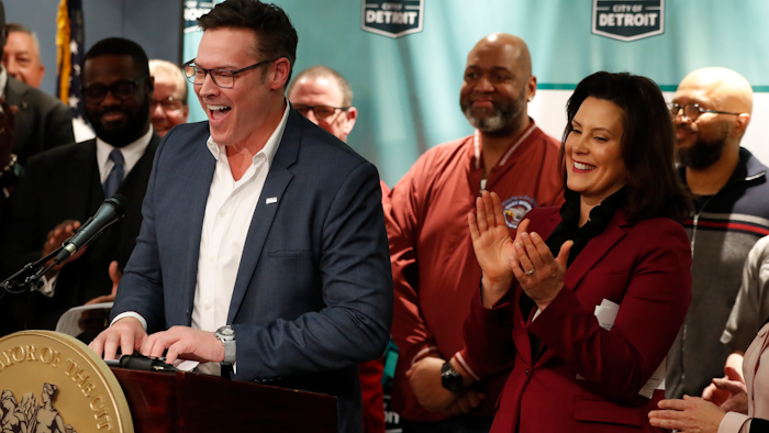 Fiat Chrysler COO Mark Stewart stands with Michigan Gov. Gretchen Whitmer during a news conference in Detroit, Tuesday, Feb. 26, 2019.