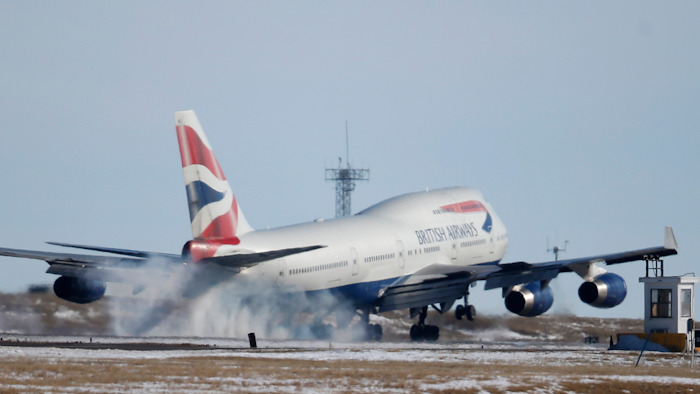 In this file photo taken Monday, Feb. 8, 2016, a British Airways plane touches down at Denver International Airport.