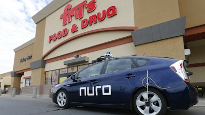 A self-driving Nuro vehicle parks outside a Fry's supermarket as part of a pilot program for grocery deliveries Thursday, Aug. 16, 2018, in Scottsdale, Ariz.