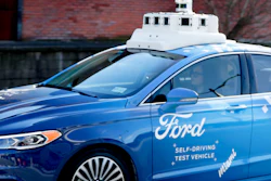 In this Dec. 18, 2018, photo, one of the test vehicles from Argo AI, Ford's autonomous vehicle unit, navigates near the company offices in Pittsburgh.