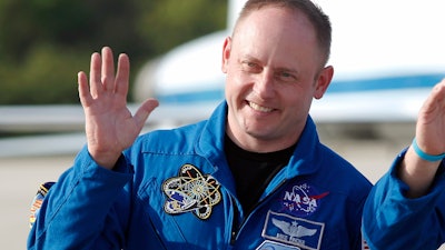 In this Tuesday, March 29, 2011, file photo, space shuttle Endeavour crew member Mike Fincke waves to onlookers after arriving for a practice countdown at Kennedy Space Center in Cape Canaveral, Fla.