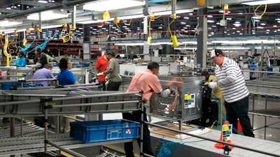 In this Thursday, Jan. 9, 2014, file photo, workers assemble ovens at the Electrolux home cooking appliance factory in Memphis, Tenn.