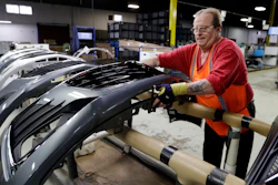 This Wednesday, Nov. 28, 2018, file photo shows Clifford Goff, a bezel assembler, transferring a front end of a Chevrolet Cruze during assembly at Jamestown Industries in Youngstown, Ohio.