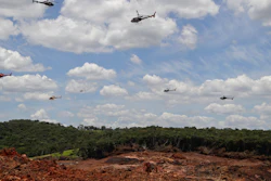 Helicopters release flower petals paying homage to victims killed after a mining dam collapsed in Brumadinho, Brazil, Friday, Feb. 1, 2019.