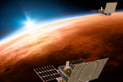 This illustration made available by NASA shows the twin Mars Cube One spacecraft flying over Mars with Earth and the sun in the distance.