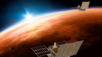 This illustration made available by NASA shows the twin Mars Cube One spacecraft flying over Mars with Earth and the sun in the distance.