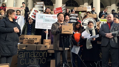This Dec. 12, 2018, file photo shows State Assemblyman Ron Kim as he speaks at a rally opposing New York's deal with Amazon on the steps of New York's City Hall.