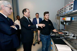 U.S. Secretary of Labor Alexander Acosta asks about the hydraulic maintenance and troubling shooting simulator with a student at the Continental Tire manufacturing plant, Friday, Feb. 8, 2019, in Clinton, Miss.