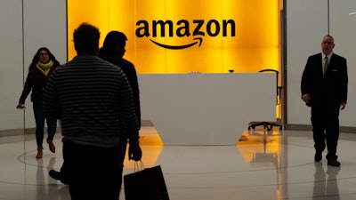 People walk into the lobby for Amazon offices Thursday, Feb. 14, 2019, in New York.