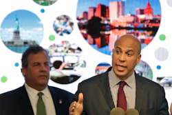 In this Oct. 16, 2017, file photo, New Jersey Sen. Cory Booker speaks while Gov. Chris Christie stands behind him during an announcement in Newark, N.J.