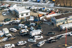 First responders and emergency vehicles are gathered near the scene of a shooting at an industrial park in Aurora, Ill., on Friday, Feb. 15, 2019.