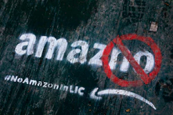 In this Nov. 16, 2018, file photo, graffiti painted on a sidewalk opposes the location of an Amazon headquarters in Long Island City.