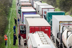 In this April 6, 2016, file photo, truck drivers stand among trucks on a highway in Spontin, Belgium.