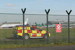 An emergency service vehicle by the perimeter fence after a confirmed drone sighting forced the temporary suspension of operations at Dublin Airport, Ireland, Thursday Feb. 21, 2019.