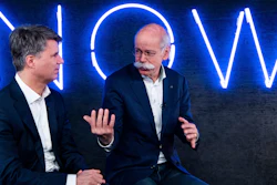 In this Friday, Feb. 22, 2019, photo, Harald Krueger, left, CEO of BMW, and Dieter Zetsche, right, CEO of Mercedes-Benz, talk during a press conference in Berlin.