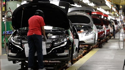 In this July 27, 2011, file photo, assembly worker Julaynne Trusel works on a Chevrolet Volt at the General Motors Hamtramck Assembly plant in Hamtramck, Mich.