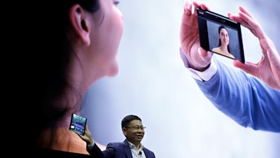Huawei CEO Richard Yu displays the new Mate X foldable 5G smartphone at the Mobile World Congress in Barcelona, Sunday, Feb. 24, 2019.