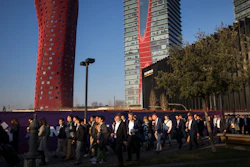 Attendees walk to enter the Mobile World Congress wireless show in Barcelona, Monday, Feb. 25, 2019.