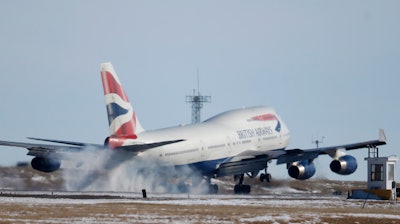 In this file photo taken Monday, Feb. 8, 2016, a British Airways plane touches down at Denver International Airport.