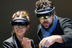 People use Microsoft Hololens to get an impression of Mercedes accessories during the International Frankfurt Motor Show IAA in Germany, Tuesday, Sept. 12, 2017.