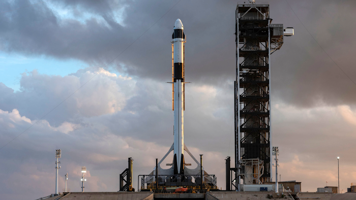 In this Jan. 3, 2019 photo, the SpaceX Falcon 9 rocket and Crew Dragon spacecraft is rolled out for a dry run at NASA's Kennedy Space Center in Florida.