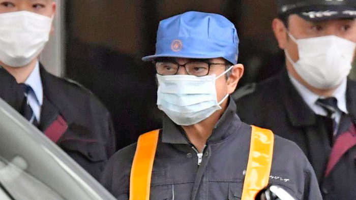 A masked man believed to be former Nissan Chairman Carlos Ghosn leaves Tokyo’s Detention Center, Wednesday, March 6, 2019.