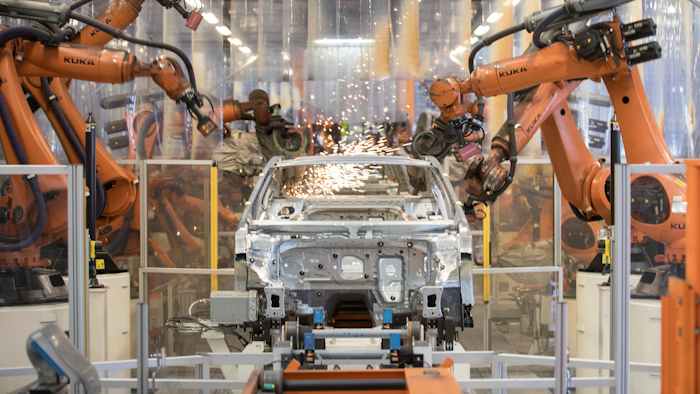 In this Saturday, March 9, 2019, file photo, robots work on a VW Passat car at a plant in Emden, Germany.