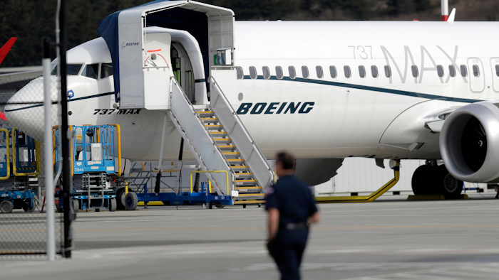 In this March 14, 2019, file photo, a worker walks next to a Boeing 737 MAX 8 airplane parked at Boeing Field in Seattle.