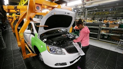 In this Monday, June 22, 2015, file photo, final trim is installed on a Buick Verano at the Orion Assembly in Orion Township, Mich.