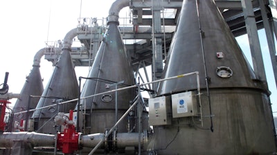 In this Feb. 21, 2019, photo, four cone-shaped machines designed to mix oxygen into river water and inject it back into the Savannah River stand on the shore of the waterway in Savannah, Ga.