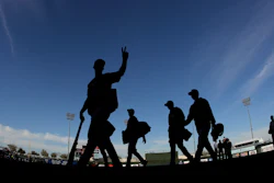 Colorado Rockies players walk off the field after a spring training baseball game against the Kansas City Royals Monday, Feb. 25, 2019, in Surprise, Ariz.