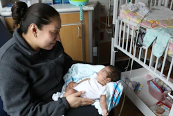 Theodora Flores holds one of her twin daughters, Genesis, in a patient room at the Ann & Robert H. Lurie Children’s Hospital of Chicago on Wednesday, Feb. 27, 2019.