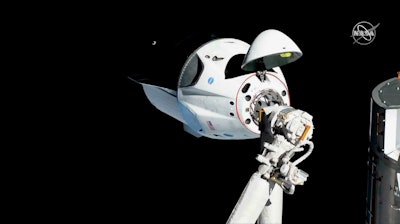 The SpaceX Crew Dragon is pictured about 20 meters away from the International Space Station’s Harmony module, Sunday, March 3, 2019.