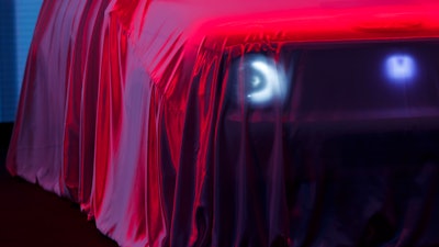 The new Honda 'E' concept car is veiled with a red dustsheet during the press day at the 89th Geneva International Motor Show in Switzerland, Tuesday, March 05, 2019.