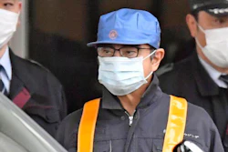 A masked man believed to be former Nissan Chairman Carlos Ghosn leaves Tokyo’s Detention Center, Wednesday, March 6, 2019.