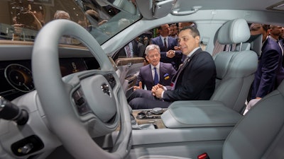 Foreign Minister Ignazio Cassis sits in an Aurus Senat car during the opening of the 89th Geneva International Motor Show in Switzerland, Thursday, March 7, 2019.