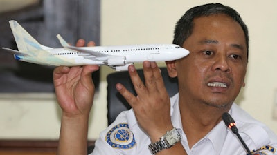 In this Nov. 28, 2018, file photo, National Transportation Safety Committee investigator Nurcahyo Utomo holds a model of an airplane during a press conference in Jakarta.