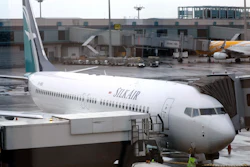 In this Oct. 4, 2017, file photo, SilkAir's new Boeing 737 Max 8 aircraft is seen through a viewing gallery window parked on the tarmac of Singapore's Changi International Airport.
