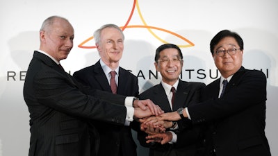 Renault CEO Thierry Bollore, Renault Chairman Jean-Dominique Senard, Nissan CEO Hiroto Saikawa and Mitsubishi Motors Chairman and CEO Osamu Masuko pose after their press conference in Yokohama, Tuesday, March 12, 2019.