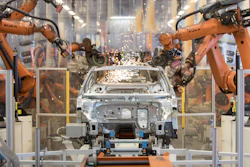 In this Saturday, March 9, 2019, file photo, robots work on a VW Passat car at a plant in Emden, Germany.
