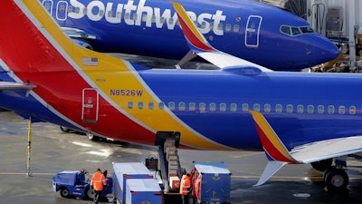 In this Feb. 5, 2019, file photo, Southwest Airlines planes are loaded at Seattle-Tacoma International Airport.