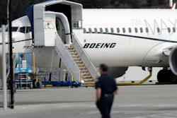 In this March 14, 2019, file photo, a worker walks next to a Boeing 737 MAX 8 airplane parked at Boeing Field in Seattle.