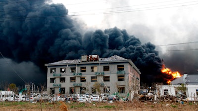 In this Thursday, March 21, 2019, photo, fires burn at the site of a factory explosion in a chemical industrial park in Yancheng, Jiangsu province.