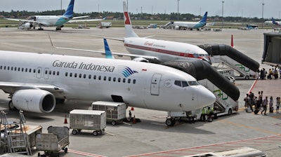 In this April 28, 2017, file photo, Garuda Indonesia planes are parked on the apron at the Soekarno-Hatta International Airport in Tangerang, Indonesia.